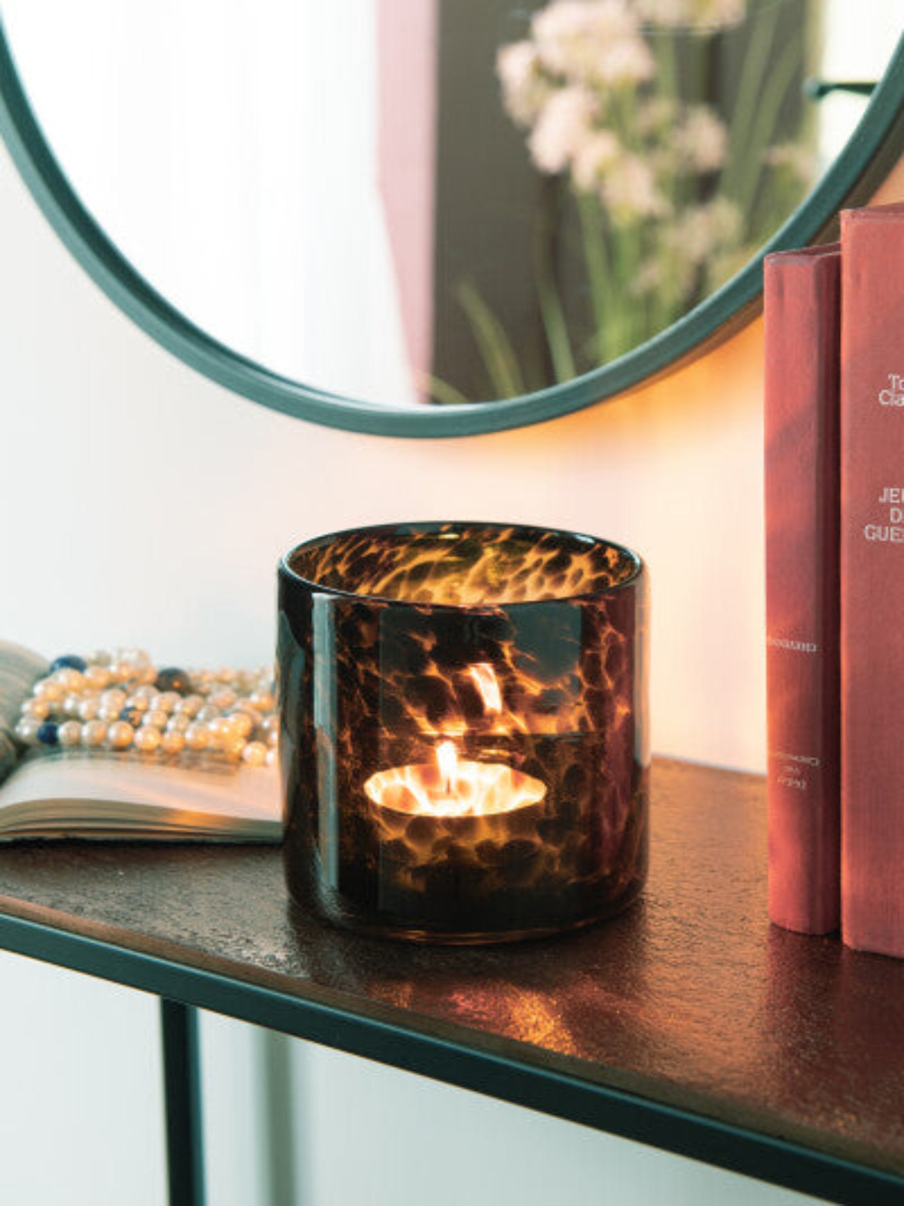 Introduce a touch of luxury to your home decor with our Brown Tortoise Glass Hurricane. The intricate dotted design adds a sophisticated and exclusive touch to any space, while the sturdy glass construction ensures long-lasting use. Available in multiple sizes, this hurricane is perfect for creating an elegant ambiance in any room. Elevate your interior with this exquisite piece.