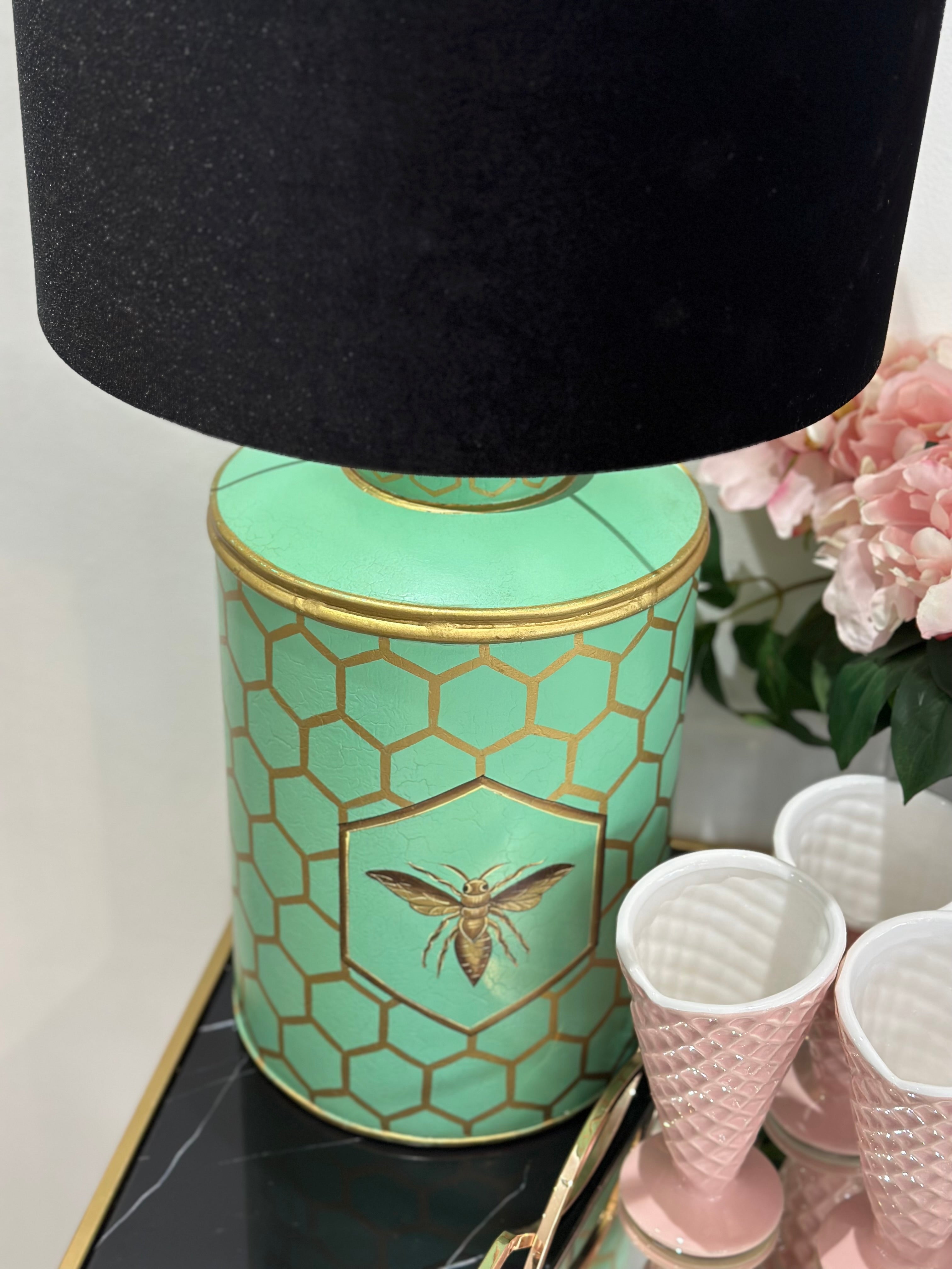 This stunning lamp features a striking aquamarine blue base adorned with gold honeycomb detailing and a beautiful bee motif.