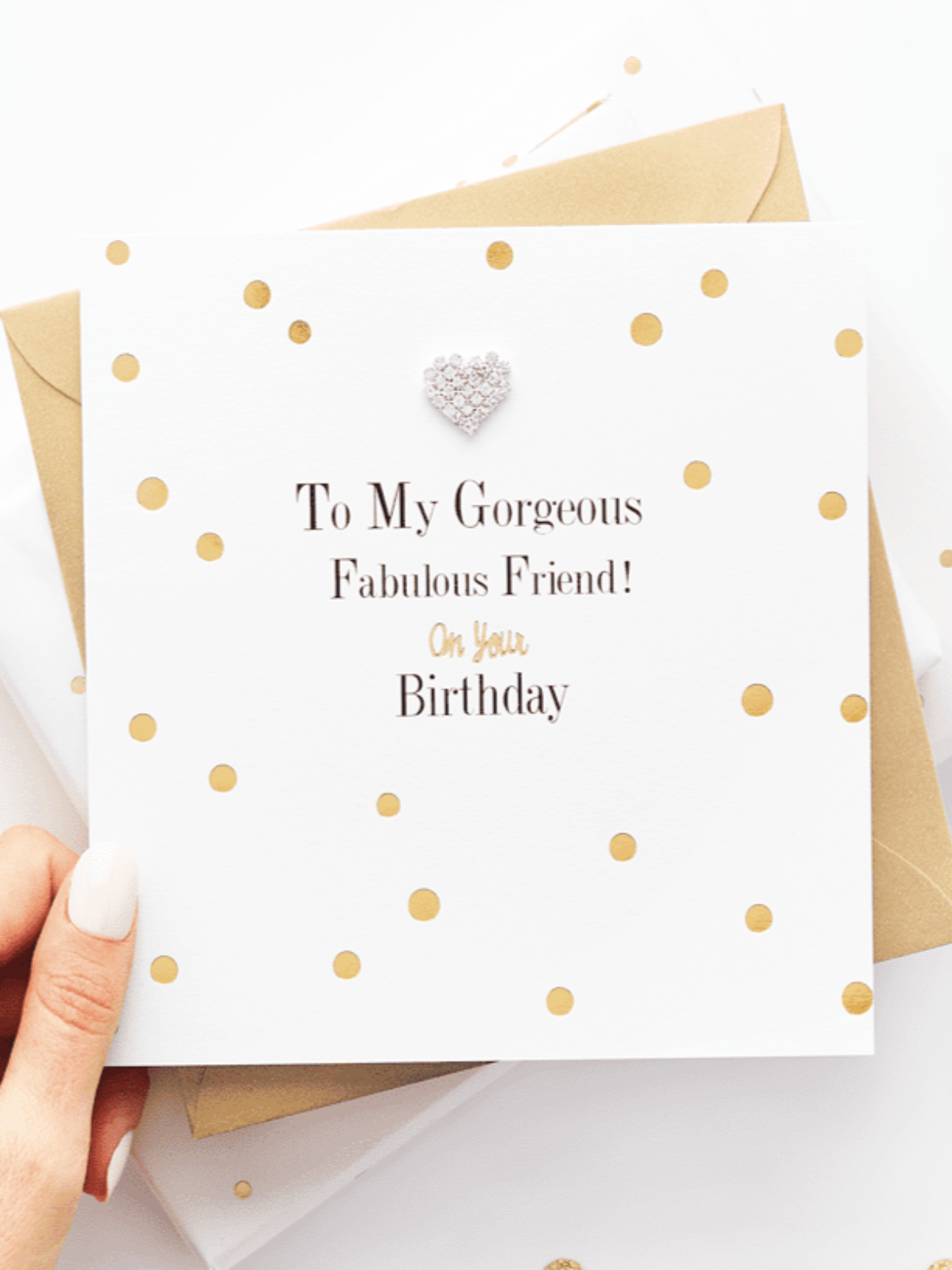 The perfect birthday card to give to your best friend. Gold and white dotted design with silver heart charm