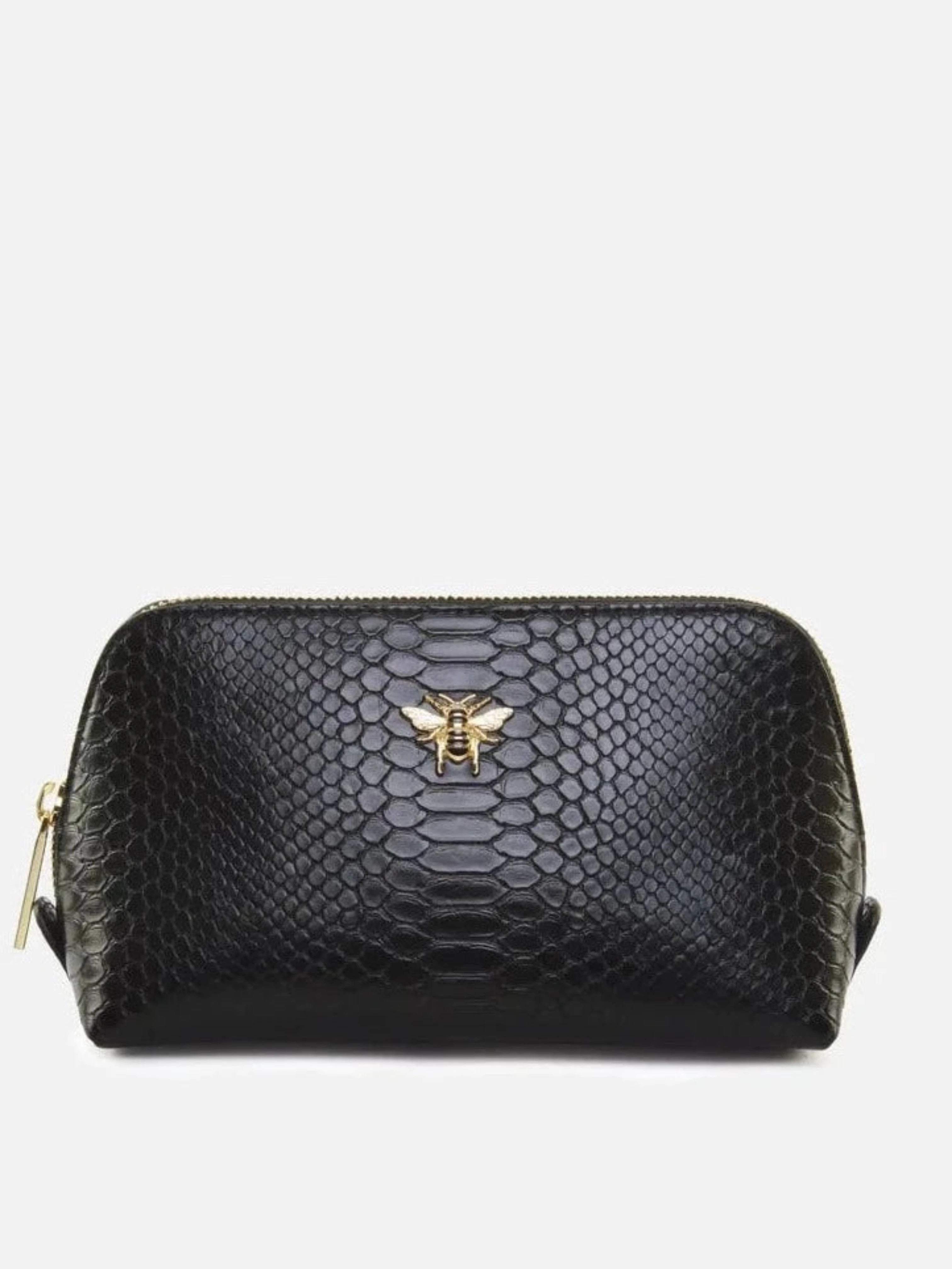 Introducing the Alice Wheeler London Large Black Snake Print Beauty Bag, a sophisticated and stylish accessory perfect for all your beauty needs. Sleek and discreetly captivating, this chic bag is crafted from beautiful black snake print fabric and features the signature Alice Wheeler logo to ensure an elite, luxurious look. Add a touch of class and sophistication to your beauty routine with this exclusive must-have.