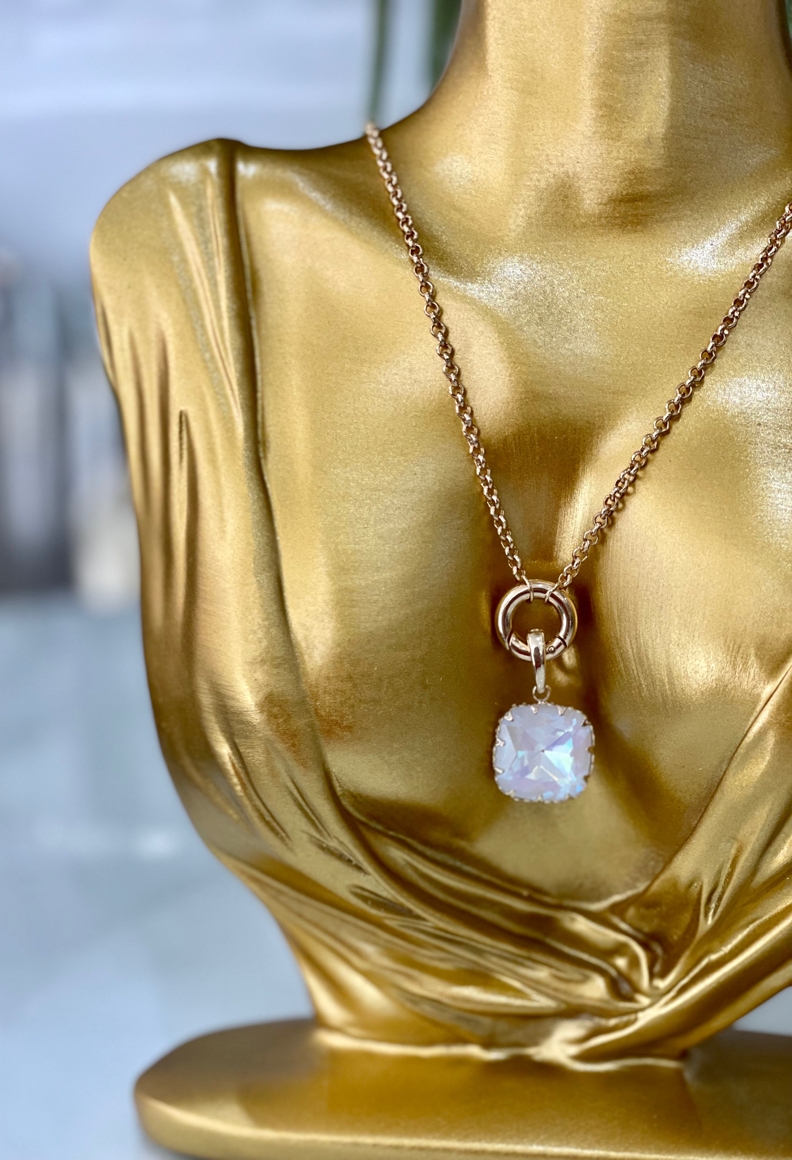 Two hand-cut glass stones delicately offset with a fancy setting, suspended from a lock mechanism for customisable charm - it's the final detail you need to take your look to the next level.